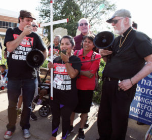 Barb Arland-Fye Antonia Alvarez, an undocumented immigrant, advocates for immigration reform during a prayer vigil and rally Aug. 20 in Davenport. Standing to the right and holding a megaphone is Father Ed O’Melia, a retired priest of the Davenport Diocese who gave the opening prayer.  