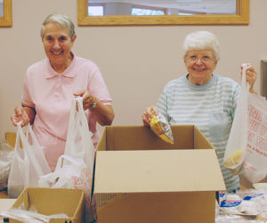 Kate Marlowe Sister Joan Theiss, OSF, and Sister Teresa Kunkel, OSF, pack lunches for Share Our Sandwiches. The project offers lunches and basic necessities to about 100 people a week. 