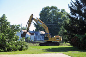Lindsay Steele A backhoe clears trees from the St. Vincent Property in Davenport Aug. 11. 