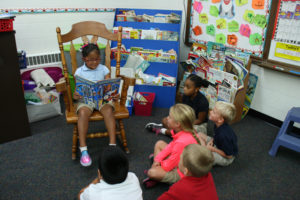 Anne Marie Amacher Carina Martinez reads to her first-grade peers at All Saints Catholic School in Davenport. The school is featured online by the Catholic Schools Advantage — Latino Enrollment Institute’s website due to its increased enrollment and increased Latino enrollment. The CSA is through Notre Dame University.