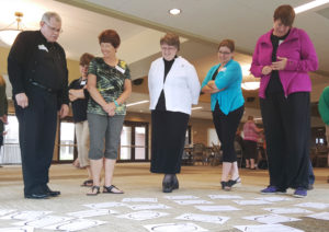 Lindsay Steele Father Robert Lathrop, Margi Mountz, Sister Cheryl Demmer, PBVM; Wendy Osterberger and Paula Thornhill view sheets of paper identifying the needs of parents at the diocesan Faith Formation Office’s annual August Gathering Aug. 28 at St. Patrick Parish in Iowa City. The event focused on how parishes can help strengthen the domestic church. 