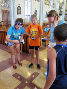 Anne Marie Amacher From left, Gillian Marbury, Brileigh McCumsey and Alexis Cummins look at the five squares of marble from St. Peter’s Basilica at the Vatican that are in the floor of St. Francis Xavier Basilica in Dyersville. 