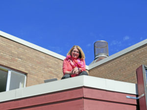 Anne Marie Amacher Principal Julie Delaney sits atop the roof of the Early Learning Center at St. Paul the Apostle Catholic School in Davenport. She spent Oct. 13 on the roof after students met their reading challenge. 