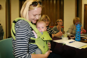 Barb Arland-Fye Beth Adamcik cuddles daughter Layne during the Strong Catholic Families Strong Catholic Youth kickoff event Oct. 7 at St. Anthony Parish in Knoxville. The Knoxville parish is the first in the Davenport Diocese to enter a three-year process to place faith at the center of family life. 