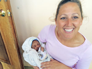Contributed Baby Dieunalson Sanon rests in the arms of volunteer Leah Hoppe at the ServeHAITI Health Center in Grand-Bois, Haiti. The baby has a congenital defect that requires surgery. 