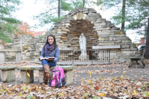 Lindsay Steele Charlette Flanders, a sophomore at St. Ambrose University in Davenport, studies in front of the grotto on campus Nov. 6.