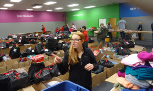 Joann McLin St. Mary-Centerville pre-confirmation student Bailey McDonald helps out with Operation Santa Dec. 9 in Centerville. Two married couples from the parish chair the annual community-wide, ecumenical project, which provides gifts and essential items to local families in need. 