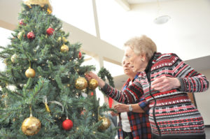 Lindsay Steele Sister Pat Miller, CHM, right, and Sister Claudellen Pentecost, CHM, decorate a Christmas tree at the Congregation of the Humility of Mary motherhouse in Davenport Dec. 16. 
