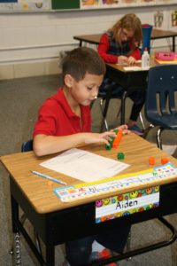 Anne Marie Amacher First-grader Aiden Nuci works on math problems at John F. Kennedy Catholic School in Davenport. Enrollment at Catholic schools in the Diocese of Davenport is up in grades K-12.