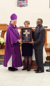 Anne Marie Amacher Karen and Jim Collins, above, and Msgr. John Hyland, belowe, receive McMullen Awards from Bishop Martin Amos Dec. 6 at St. Ambrose University.