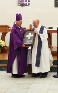 Anne Marie Amacher Msgr. John Hyland receives his McMullen Award from Bishop Martin Amos Dec. 6 at St. Ambrose University. 