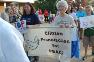 Kate Marlowe Sister Marilyn Shea, OSF, right, and Sisters of St. Francis employee Amanda Eberhardt carry a peace banner during the Stop the Hate walk in Clinton in 2014. The Sisters of St. Francis are celebrating their 150th anniversary as a community this year. 