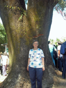 Contributed Sister Johanna Rickl, CHM, poses in front of a tree at the site where four churchwomen were murdered Dec. 2, 1980, in El Salvador. Sr. Rickl was among pilgrims at the site Dec. 2, 2015, to commemorate the women’s lives.   
