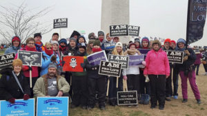 Contributed Catholics from the Diocese of Davenport stand with pro-life signs in front of the Washington Monument during March for Life in Washington, D.C. last month.