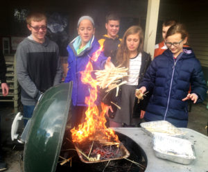 Contributed Youths and adults from St. James Parish in Washington burn palms to make ashes for Ash Wednesday.