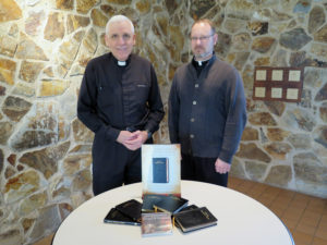 Anne Marie Amacher Father William Kneemiller and Father Jason Crossen show a display of the “Shorter Christian Prayer – Liturgy of the Hours” at Our Lady of Lourdes Parish in Bettendorf. Fr. Kneemiller encourages parishes to promote Liturgy of the Hours for home or parish this Lent.
