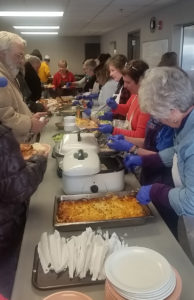 Contributed Members of the cluster parishes in Wellman, Riverside and Richmond serve food at Iowa City’s Free Lunch Program Feb. 9. It’s one of several corporal works of mercy the cluster is practicing during the Year of Mercy.