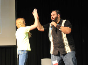 Lindsay Steele Tony Vasinda, right, high-fives a junior high youth at the 2015 Junior High Youth Rally at Regina Education Center in Iowa City. Vasinda returns as a presenter for this year’s rally, which will also feature a pilgrimage to St. Mary Parish-Iowa City for the Year of Mercy. 