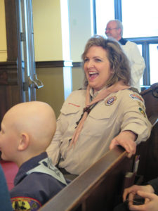 Anne Marie Amacher Denise Walsh McMonagle, chair of the Davenport Diocese Catholic Committee on Scouting, laughs during the annual scouting religious emblems ceremony Feb. 28. She was reacting to Bishop Martin Amos’ face as he learned he was a St. George emblem award winner. 