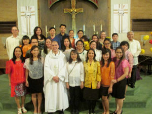 Father Jim Betzen Father Joseph Sia, center, poses for a picture with Filipino Catholics after a Filipino Mass April 9 at St. Mary of the Visitation Church, Ottumwa. 