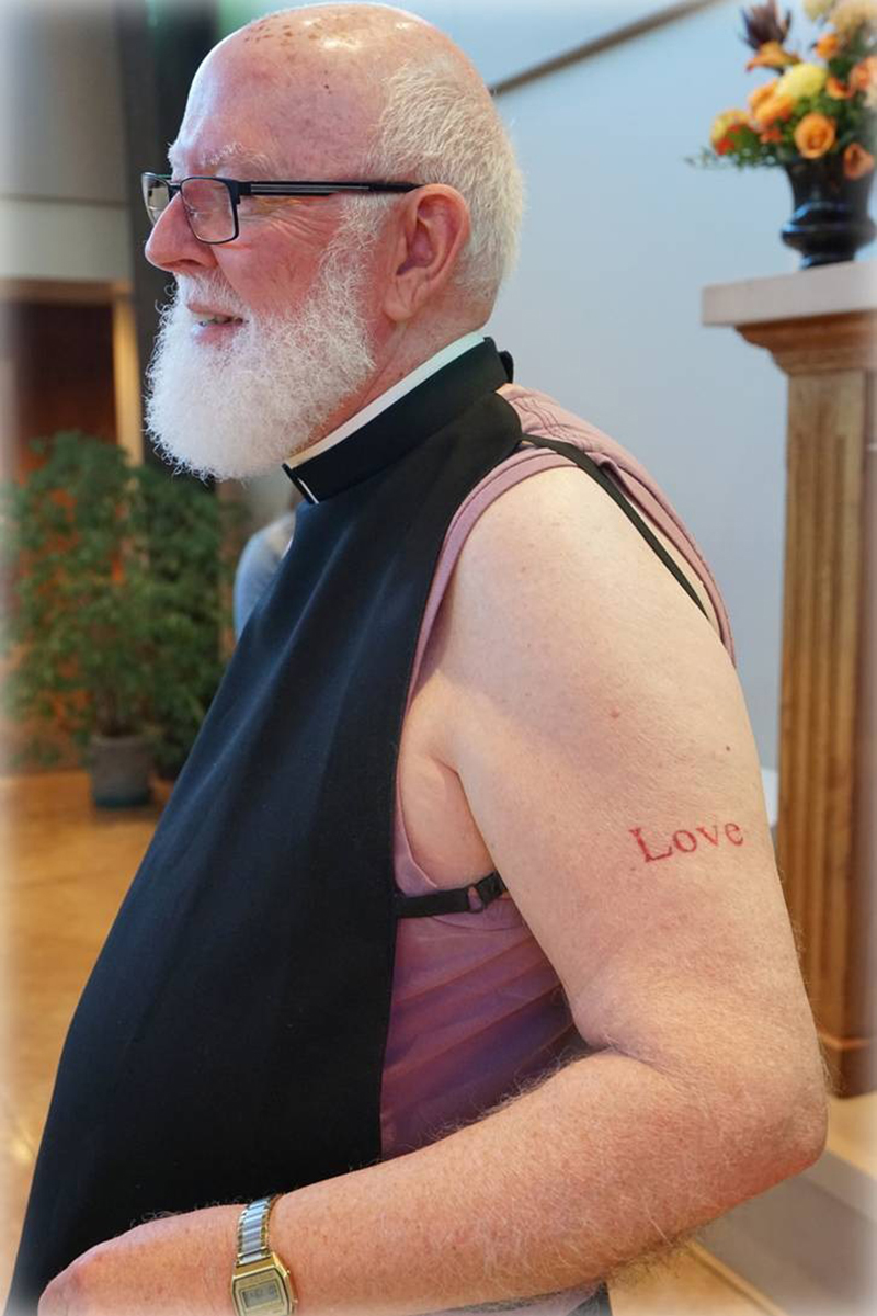 Contributed Father Bill Reynolds shows off his temporary tattoo. Fr. Reynolds used the tattoo as part of his homily for Pentecost.