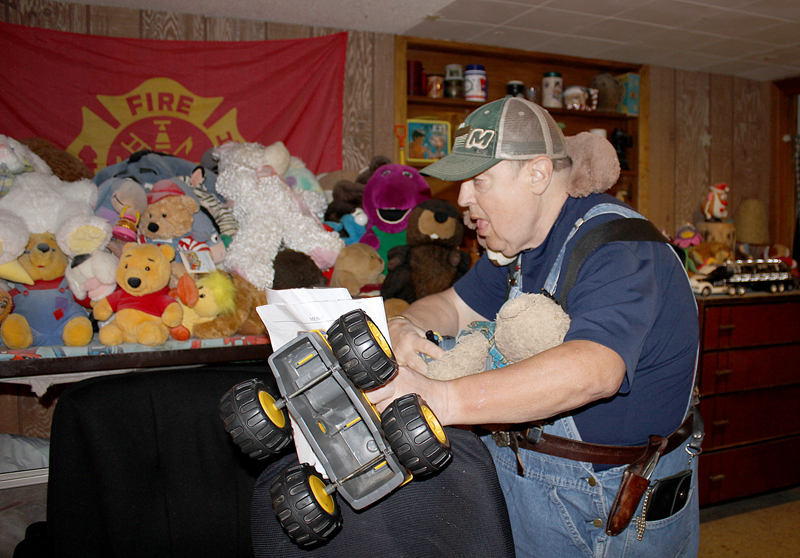 Barb Arland-Fye David Bricker gathers his favorite things: a toy tractor, his beloved teddy bear and another stuffed animal he wraps around his neck at his home near Victor, Iowa. David, who has a developmental disability, lives with his mom, Verabeth Bricker, and his sister, Denise Bricker. They take care of him, along with home health worker Anna Upah.