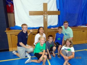 Contributed Seminarians Ben Snyder, left, and Cameron Costello, right, help youths during Totus Tuus at Prince of Peace Catholic School in Clinton June 14.  