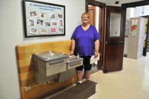 Lindsay Steele Shelly McIntosh, licensed director of St. Alphonsus Early Childhood Education Center in Davenport, stands outside one of the restrooms in the facility which will be updated this summer to become safer and include handicap-accessible stalls. 