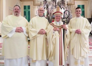 Anne Marie Amacher Bishop Martin Amos poses with his newly ordained June 4 at Sacred Heart Cathedral in Davenport. From left, Deacon Christopher Weber and Deacon Dan Dorau were ordained transitional deacons. At right, Father Ross Epping was ordained to the priesthood.