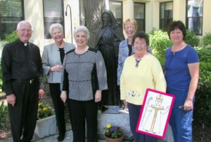 Contributed Pictured at St. Joseph’s Home in Palatine, Ill., are from left, Bishop Martin Amos, Judy Kirberg, Jeanne Rauhaus, (at statue of St. Jeanne Jugan), Marcia Moore, Lu Ann Farrell with Flat Amos and Kay Temple.