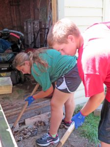 Anne Marie Amacher Abby and Adam Allen of St. Ann Parish-Long Grove, dig dirt to lower a ramp in Muscatine during Catholics in Action-Family Style earlier this month.