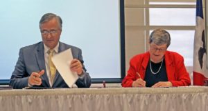 Anne Mari e Amacher Don Doucette, chancellor of Eastern Iowa Community Colleges, and Sister Joan Lescinski, CSJ, president of St. Ambrose University in Davenport, sign new transfer agreements between the two entities July 15.