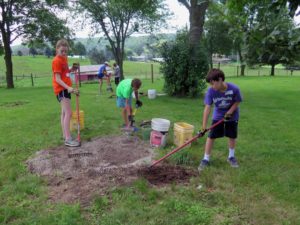Anne Marie Amacher Catherine Carroll, Jonathan Lukas and Jack Perhach, all of Wisconsin, prepare a site for sod replacement at Eagles’ Wings in Davenport.