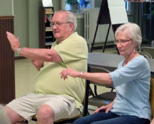 Anne Marie Amacher Marv and Cindy Stolley do diagonal arm presses during a balance class at Holy Family Parish in Davenport on July 11.