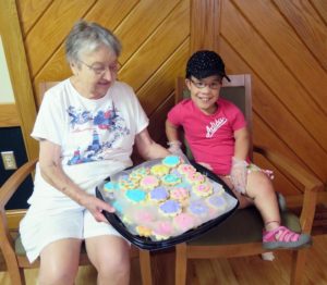 Anne Marie Amacher Cariyana Cummins of St. Peter Parish in Buffalo shows off cookies made by youths and seniors during a service event in June. With Cariyana is Sister Ludmilla Benda, RSM, who took the cookies to serve to the less forunate at Father Conroy’s Vineyard of Hope.