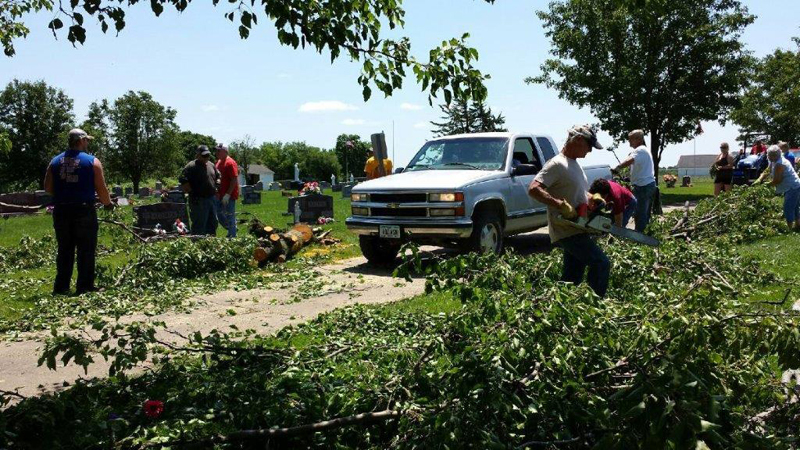 Sharon Crall Volunteers clean up the Catholic cemetery in Albia following a tornado last year. 