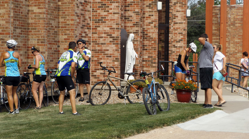 Fr. Bill Hubmann, C.PP.S RAGBRAI participants park their bicycles outside St. Mary Parish in Centerville July 27. This year’s RAGBRAI route passed through southern Iowa, with three overnight stops in the Diocese of Davenport. Parishes offered camping space and/or food to riders.  