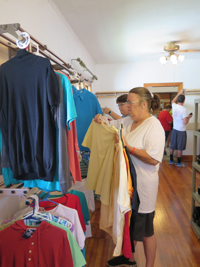 Anne Marie Amacher Gladys Goban places clothing on racks at the newly relocated Clothing Center at Minnie’s Maison in Davenport. The center was formerly known as the Sacred Heart Clothing Center  and is now located at 1119 LeClaire St. 