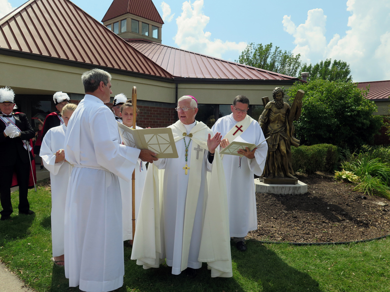 Anne Marie Amacher Bishop Martin Amos reads a blessing for a statue of St. Andrew and St. Andrew Parish in Blue Grass Aug. 18. Assisting are Dan Freeman, left, a deacon candidate, and Deacon Terry Starns, right, parish life coordinator. 