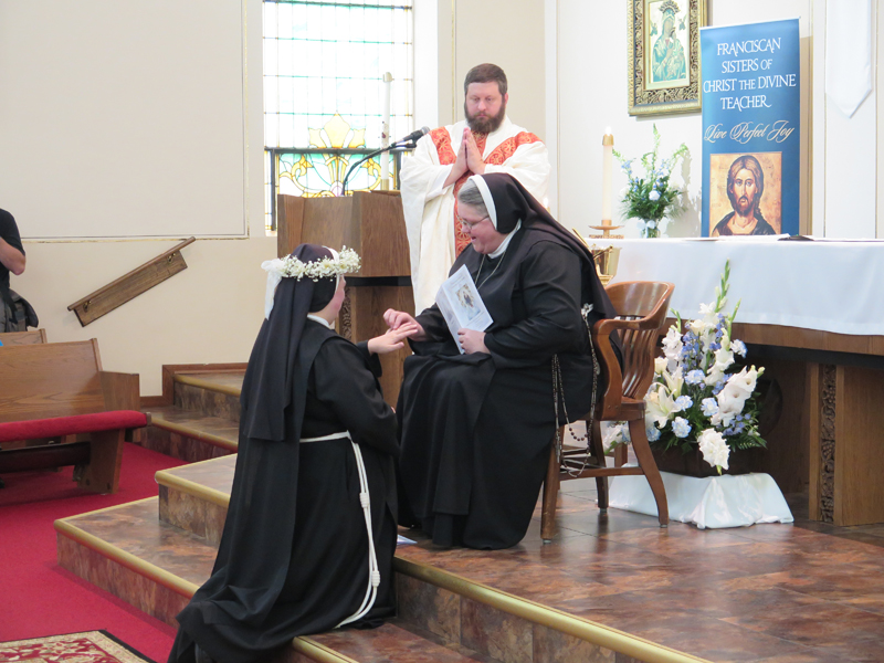 Anne Marie Amacher Mother Susan Rueve places a ring on the finger of Sister M. Anthony Worrell as part of the final vows taken by Sr. Anthony. Father Paul Appel blessed the ring prior to it being placed on the finger of Sr. Anthony Aug. 2 at St. Alphonsus Parish in Davenport.