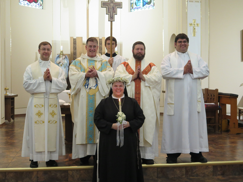 Anne Marie Amacher Sr. Anthony Worrell beams after taking final vows at St. Alphonsus Church in Davenport. She is joined by Fathers Tom Hennen, Scott Lemaster, Paul Appel and Guillermo Trevino. 