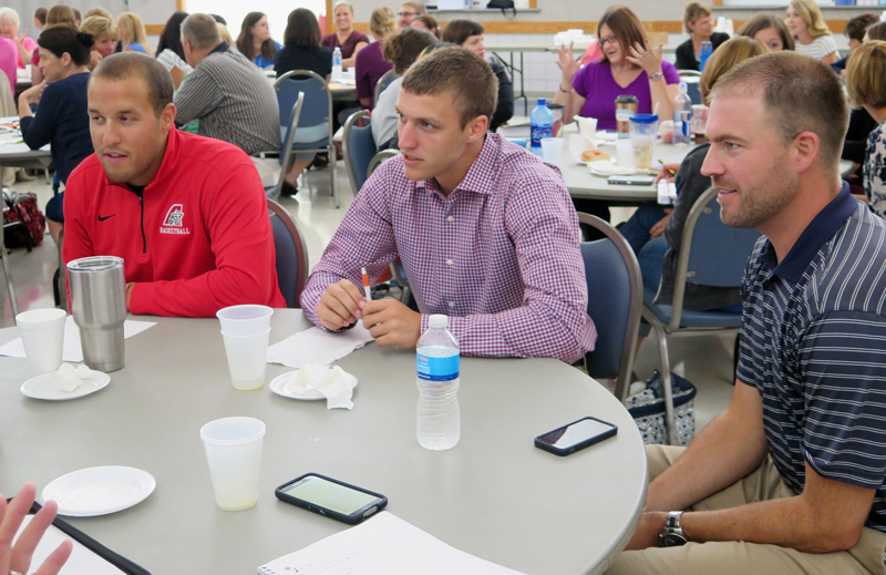 Anne Marie Amacher Assumption High School teachers Anthony Wittemeyer, Jacob Timm and Matt Fitzpatrick listen during a discussion at a teacher in-service Aug. 17 at St. Paul the Apostle Parish in Davenport.
