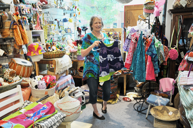 Lindsay Steele Becke Dawson, owner of SIS International in Davenport, shows off some fair trade children’s clothing. Buying fair trade clothing is one way to support living wages and safe working environments for textile workers around the world.  