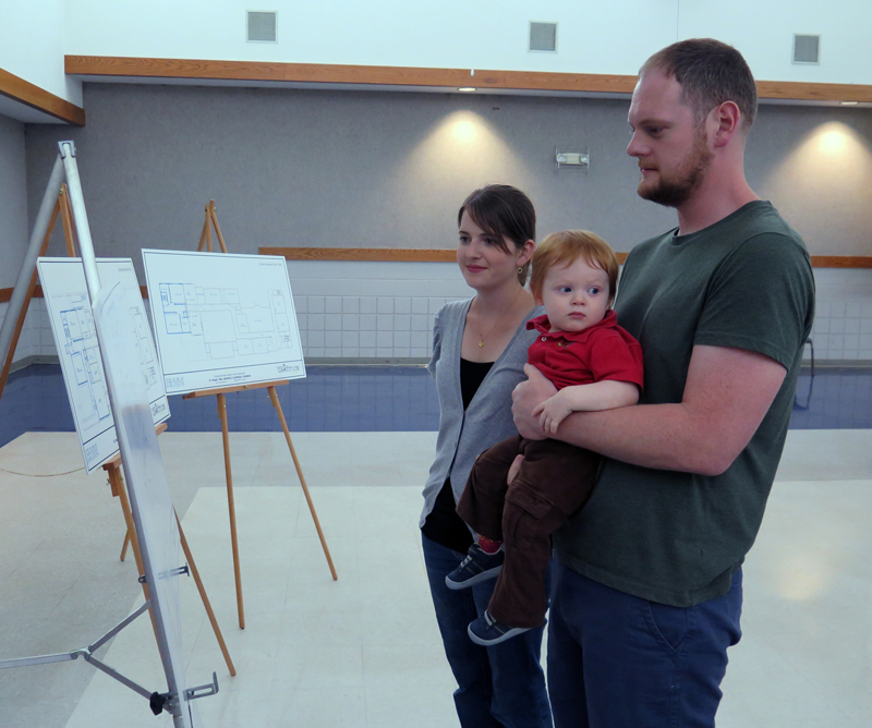 Anne Marie Amacher Ben and Amy Kolner, along with their son Will, look at plans for improvements at St. Paul the Apostle Parish and School Sept. 17. A capital campaign was kicked off at all weekend Masses at the parish. 