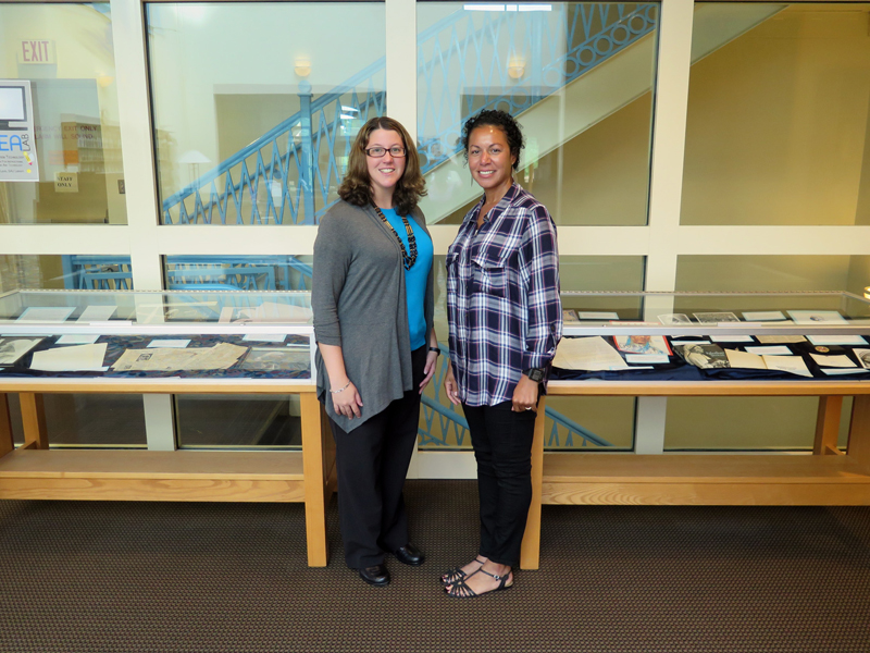 Anne Marie Amacher Archivists Onnika Marquez, left, and Tyla Cole stand by two display cases with items about now St. Teresa of Kolkota. The display is at St. Ambrose University in Davenport and is open to the public. 