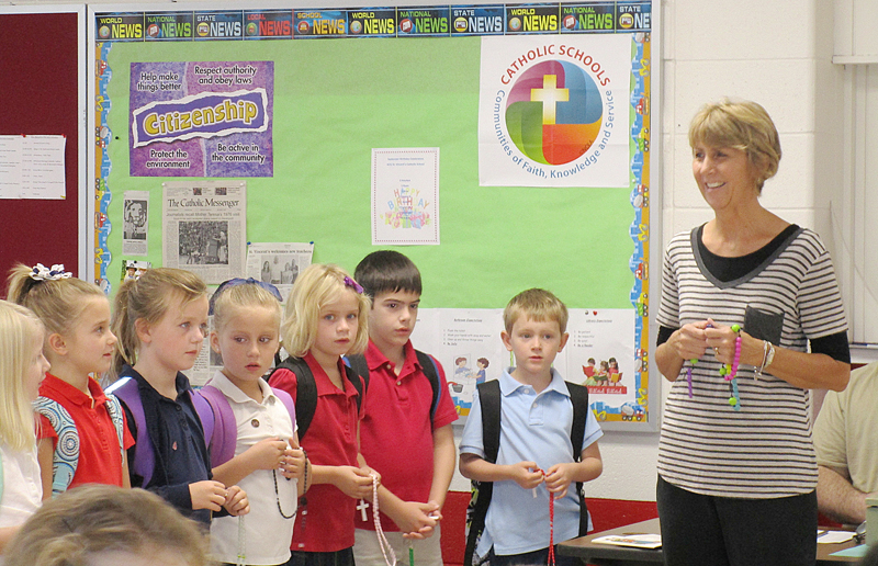 Tammy Boyle St. Vincent School-Keokuk teacher Shelley Williams leads students in praying the rosary earlier this month.  