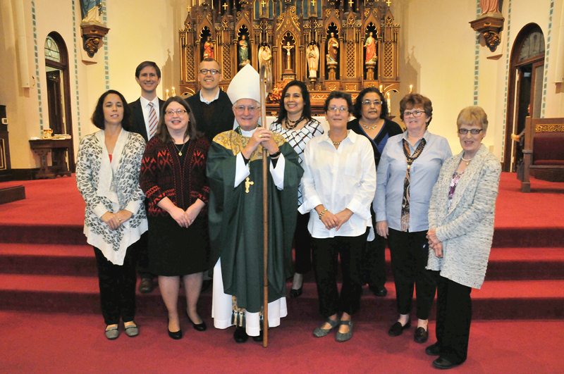 Lindsay Steele Bishop Martin Amos, center, poses for a picture with the newly commissioned lay ecclesial ministers from the Ministry Formation Program. They are, from left, Rebecca Hannum, St. Mary Parish-West Point; Andrew Reif, St. Mary Parish-Dodgeville; Jane and William Doucette, St. Mary Parish-Iowa City; Karina Garnica, Sacred Heart Parish-Davenport; Lori Smith, St. Mary Parish-Oskaloosa; Juana Plum, St. Mary Parish-Albia; Jane Playle-Kauzlarich and Donna Tylkowski, St. Mary Parish-Oskaloosa. 
