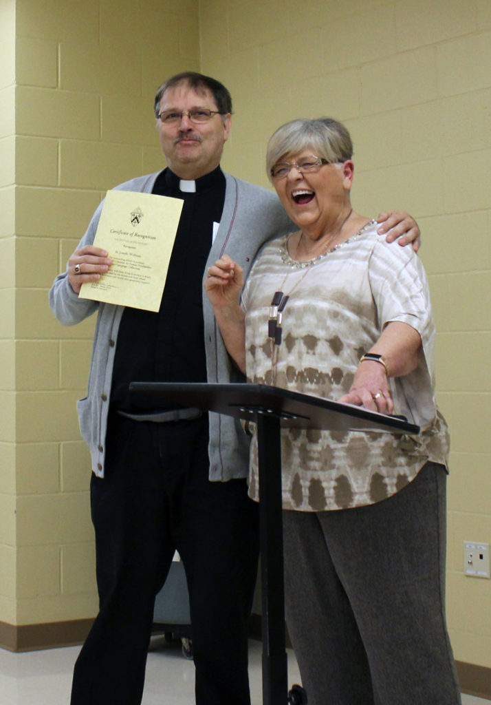 Barb Arland-Fye Father David Brownfield and volunteer CCHD director Loxi Hopkins share a laugh during a CCHD luncheon Oct. 15.