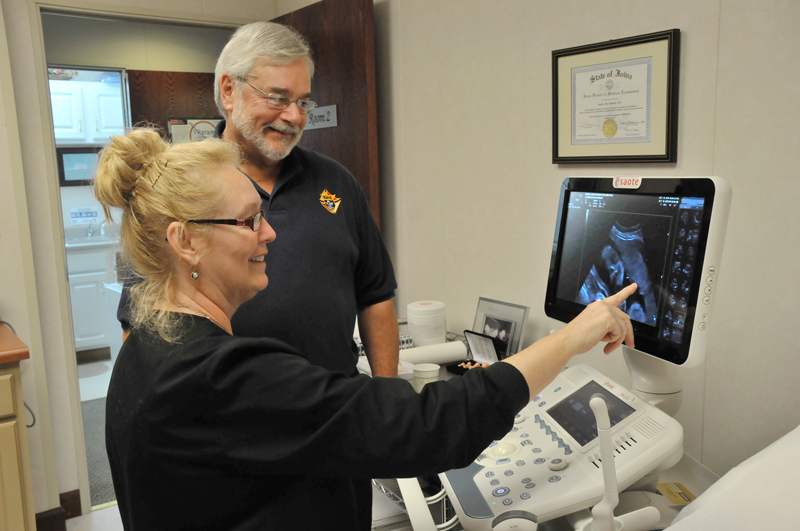 Lindsay Steele Pam Galanius, clinical director for the Women’s Choice Center in Bettendorf, shows an ultrasound image to Knight of Columbus Jack Swan Oct. 19. 