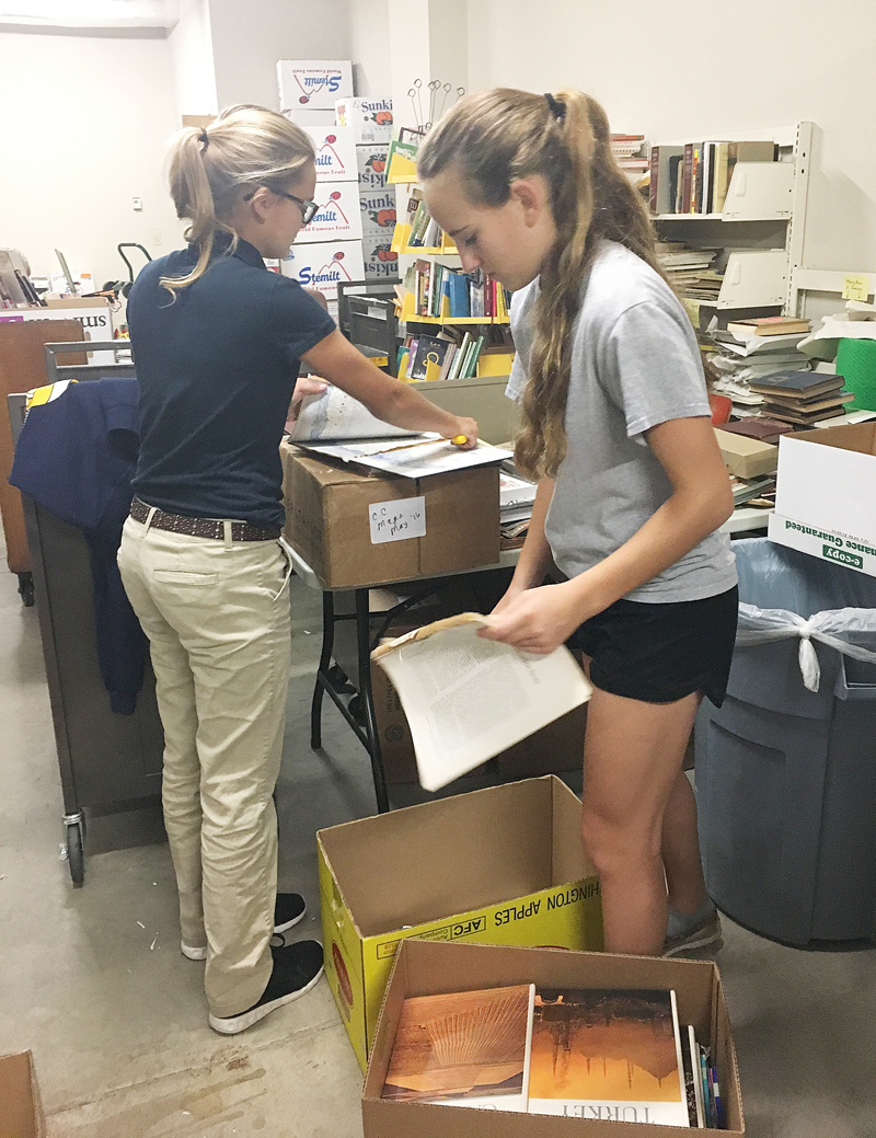 Contributed Taylor Ackerman, left, and Grace Dupuis, members of Burlington Notre Dame’s Leo Club, volunteer at the Burlington Public Library earlier this month. Catholic educators and parents recently attended the Iowa School Choice Summit in Des Moines.